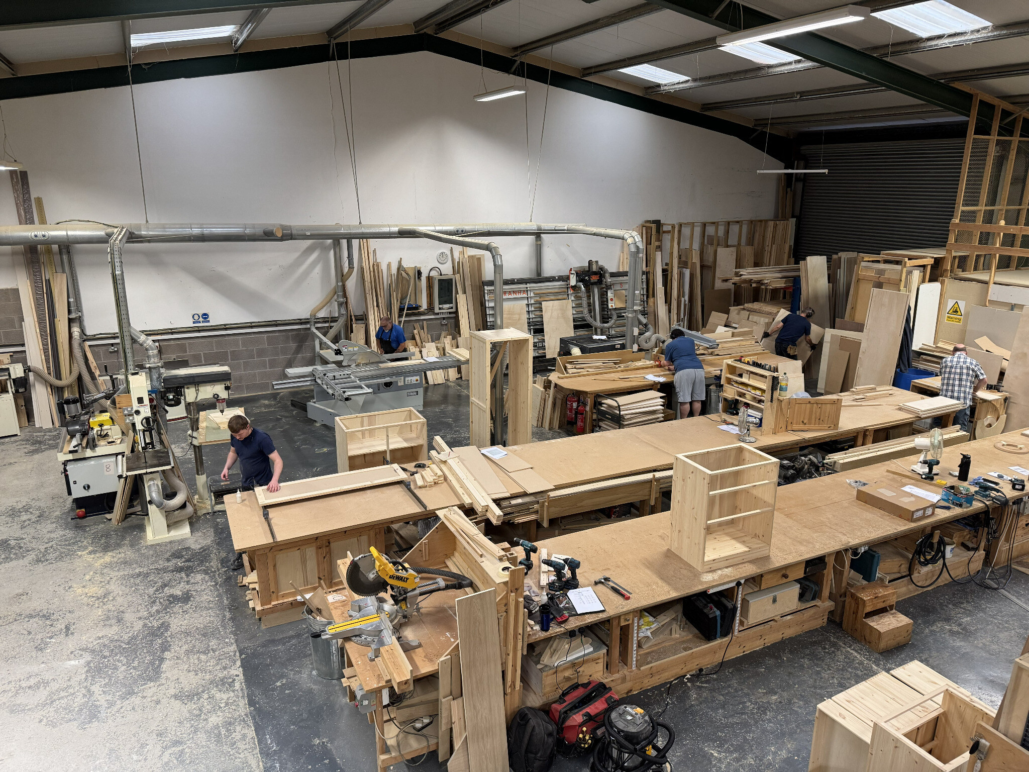The Dorset Kitchens team making bespoke cabinets in the workshop
