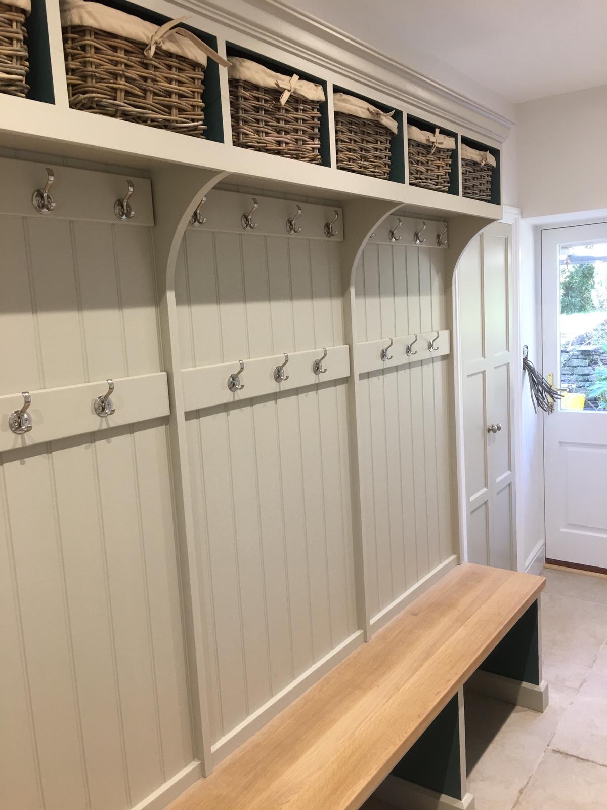 Painted boot room with oak bench and coat hooks