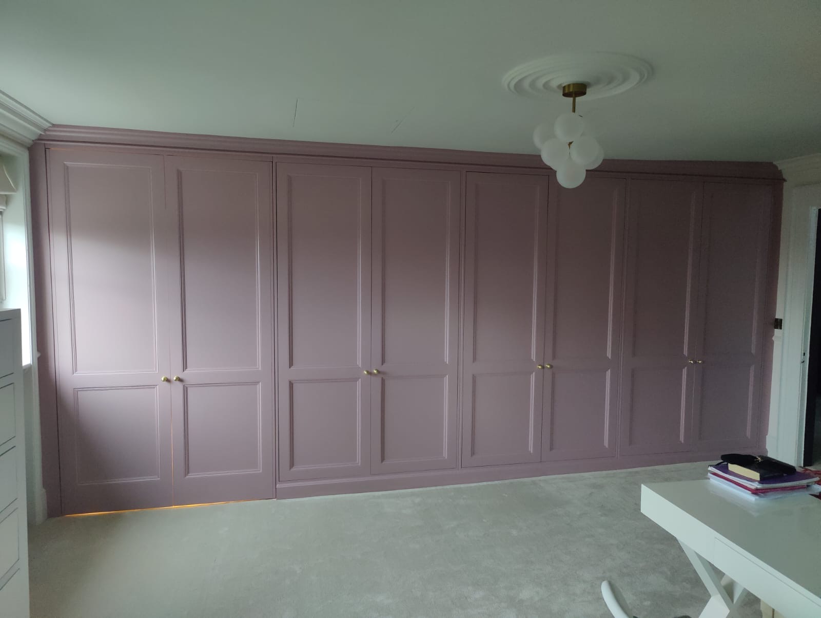 Wall-to-wall fitted wardrobes with hand-painted panelled doors