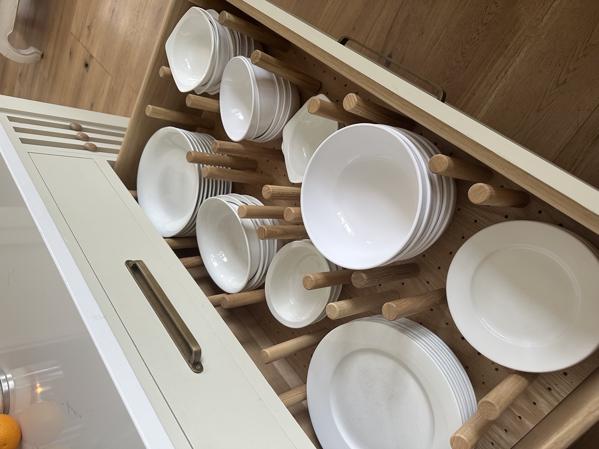 Bespoke oak plate-storage drawer with adjustable wooden pegs